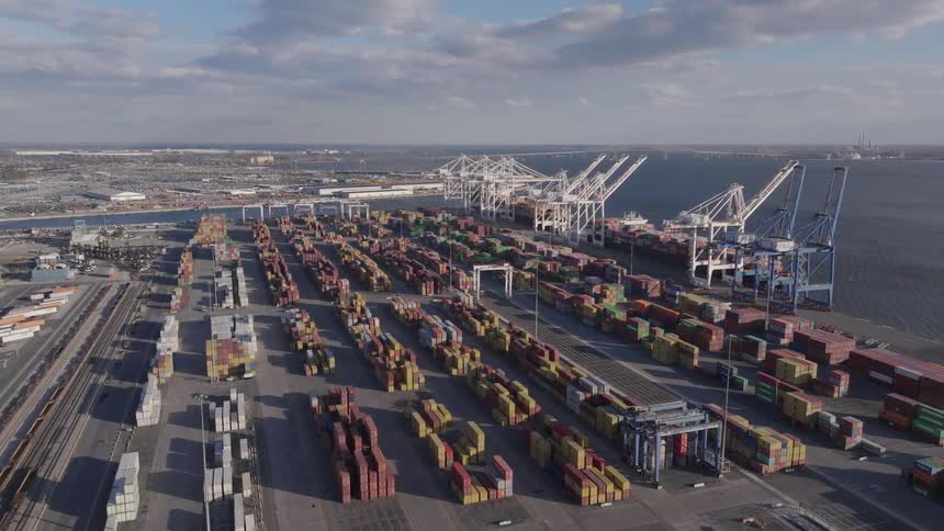 Aerial scene of a port with seaside containers and cargo ships docked