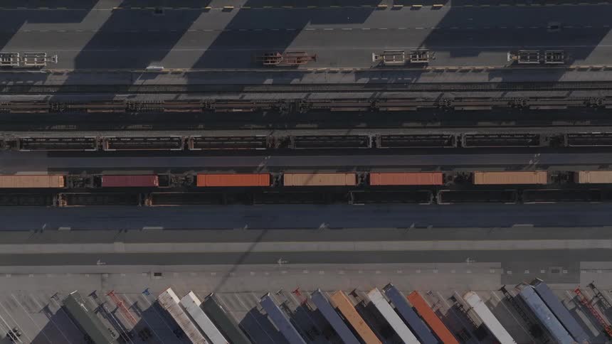 Aerial panorama of a moving train in a logistics center