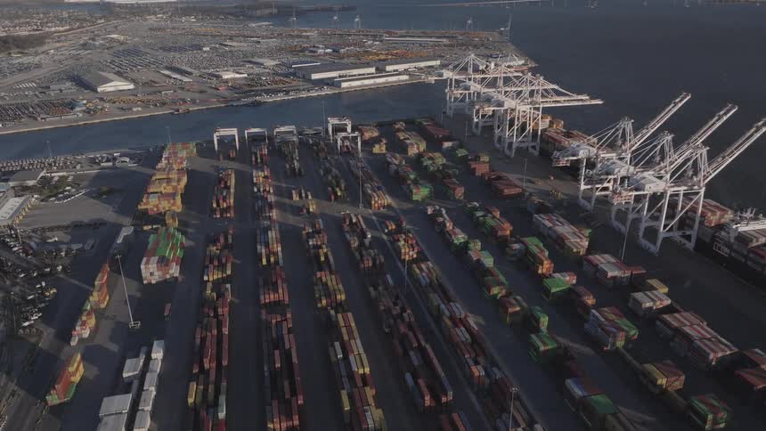 Aerial panorama of a pig with organized containers and the seaside