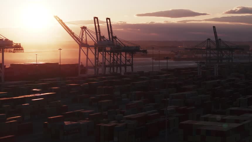 A large port with cranes on a coast