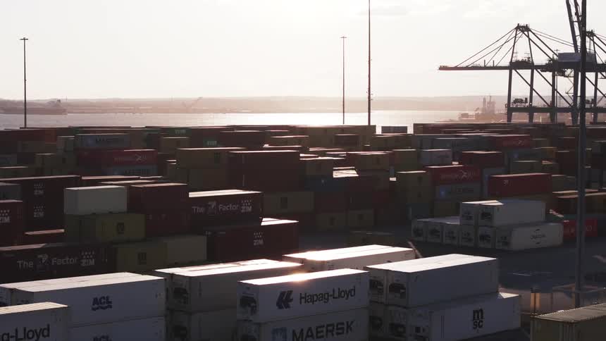 Aerial view of stacked shipping containers in a container yard