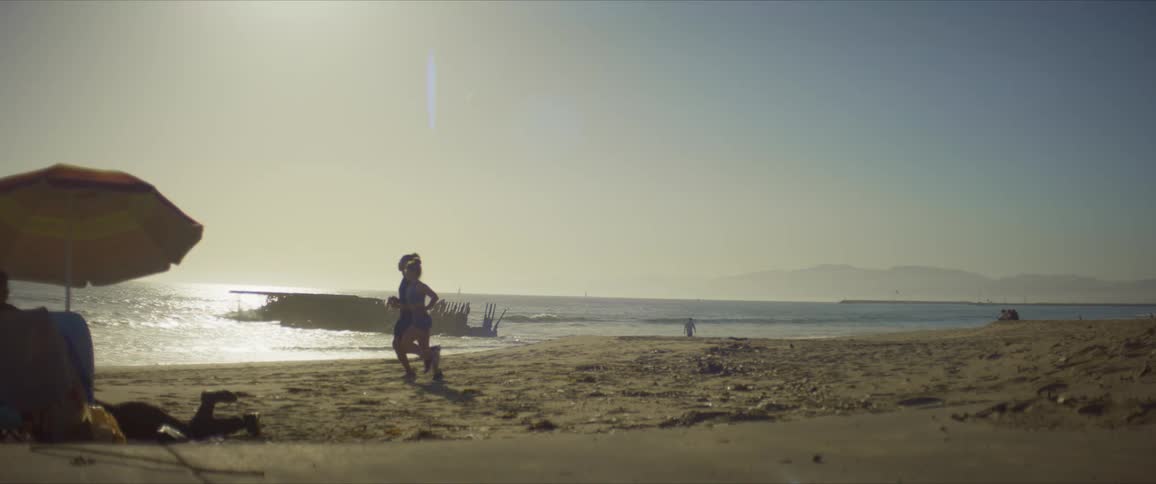 Man and woman running on the sand of the beach