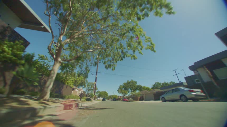 A man and a woman wearing green sports outfits run down the street