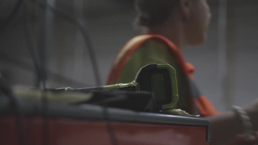 Worker standing near handheld scanner in warehouse walks away