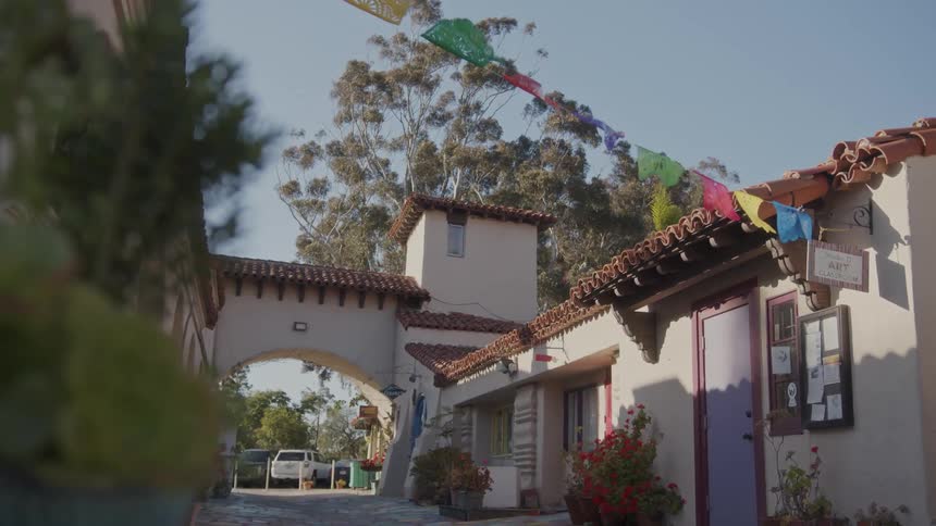 The buildings with tile roof located in balboa park is home to the spanish village art center