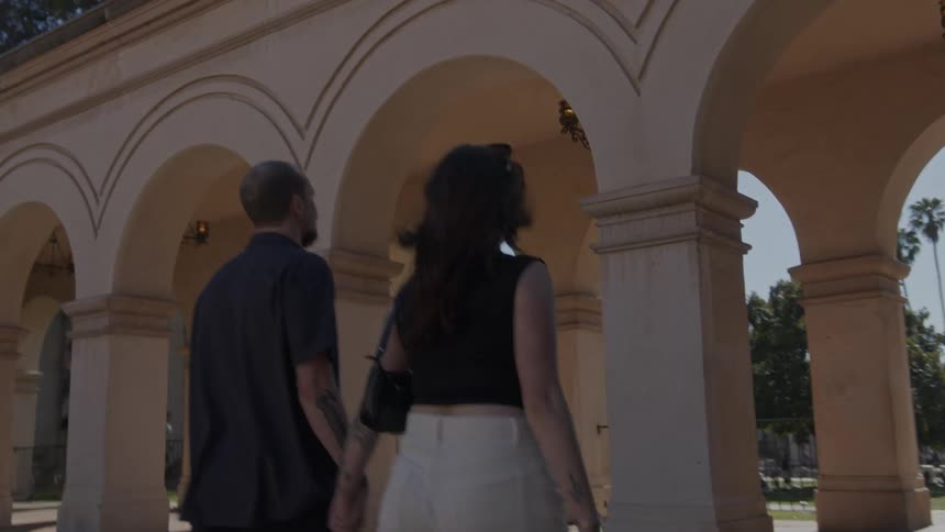 A man and woman walk to the park