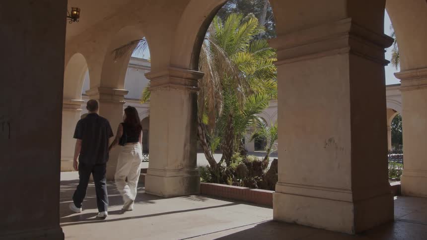 A couple strolls through casa del prado hand in hand