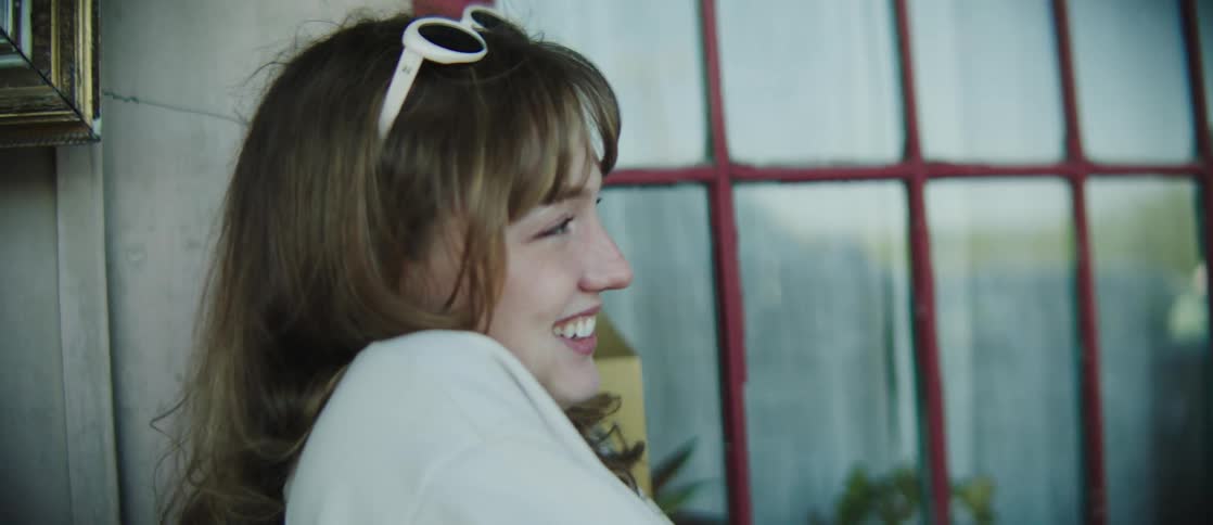 A clip of a lady laughing and having a conversation