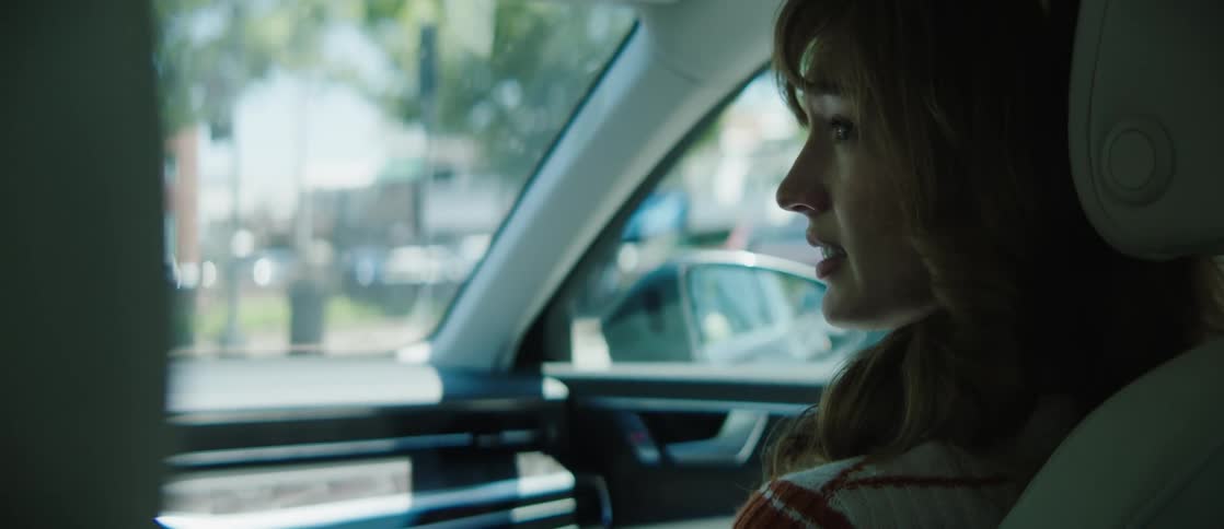 A footage of a lady having a conversation in a car