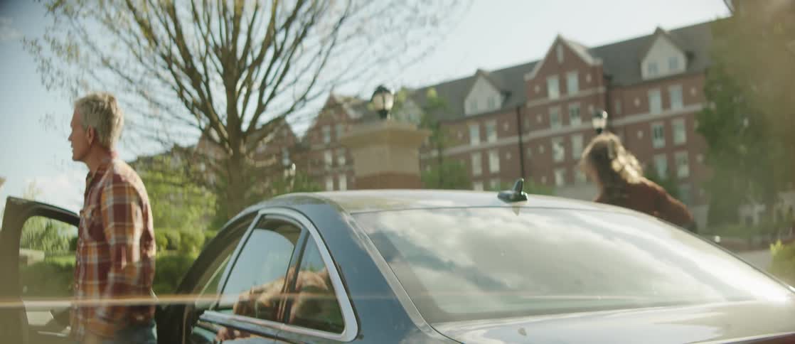 A father and daughter get out of the car near the school