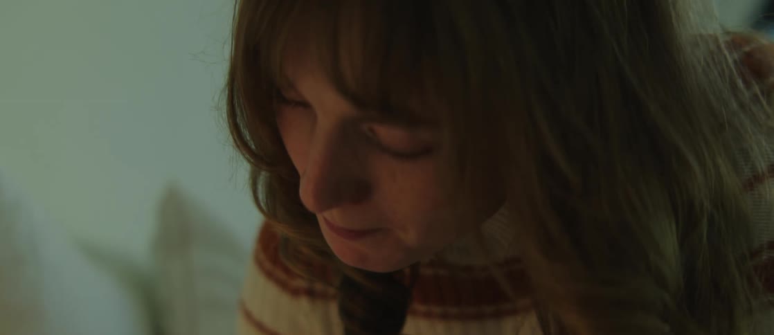 A woman indoors thinking and focusing on something