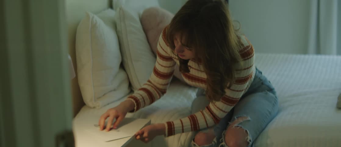 A woman leaving a handwritten note in the bedroom