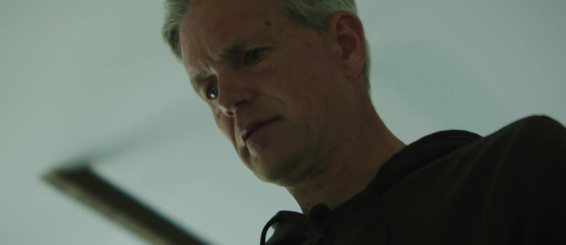 Portrait of a man indoors tilting his face