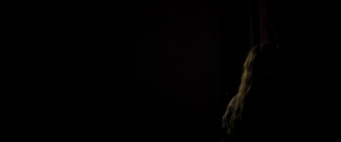 Silhouette of a woman turning off the lights in a room