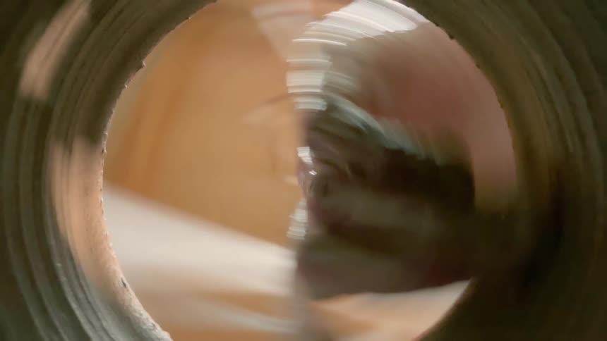 Spinning footage from the interior of a clay vase being shaped