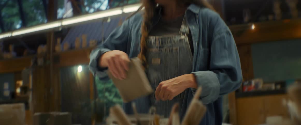 Woman cutting clay block on the table