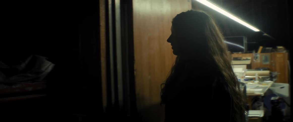 Woman entering a room and turning on the lights