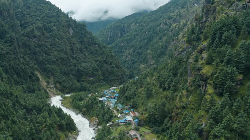 A rural community next to a river in a mountain valley