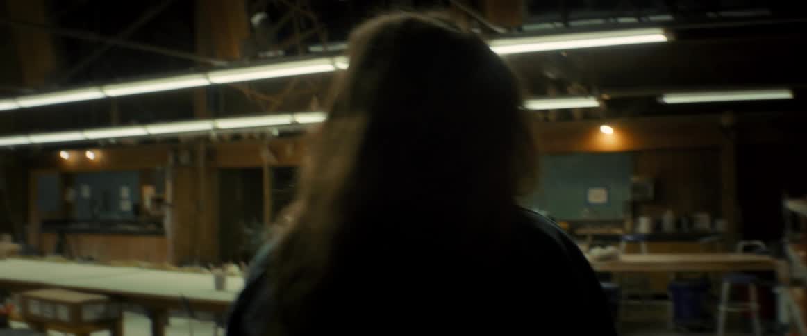 Woman entering a room and turning on the light