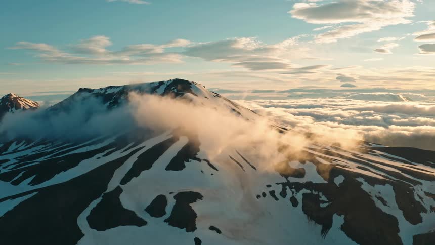 Aerial panorama of snowcovered mountain ranges in a morning