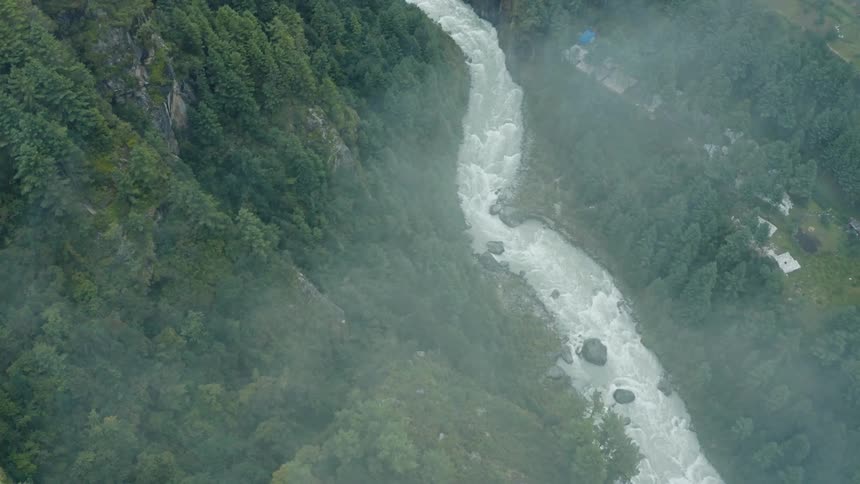 Wispy clouds float over a river near a rural community