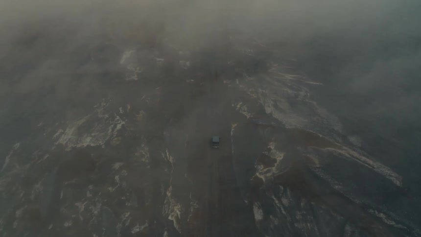 The vehicle drives through the sand storm