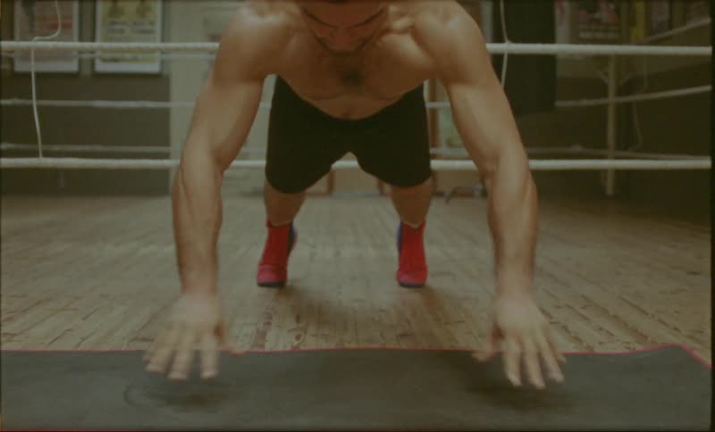 Boxer doing pushups with closed and open hands