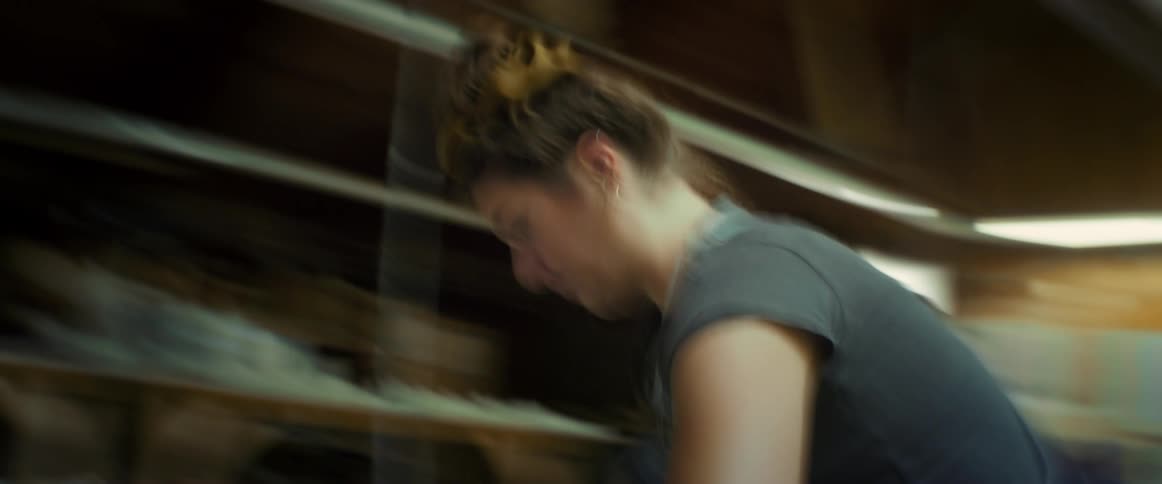 Woman sitting indoors working with her hands dirty with clay