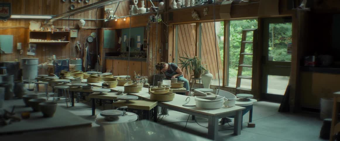 A potter sculpts clay using a potters wheel