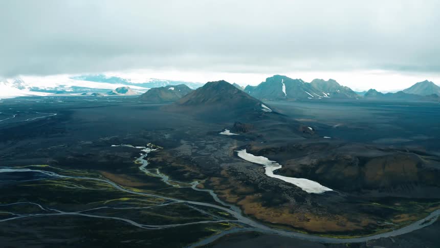 Aerial landscape of mountains with rivers on a cloudy day