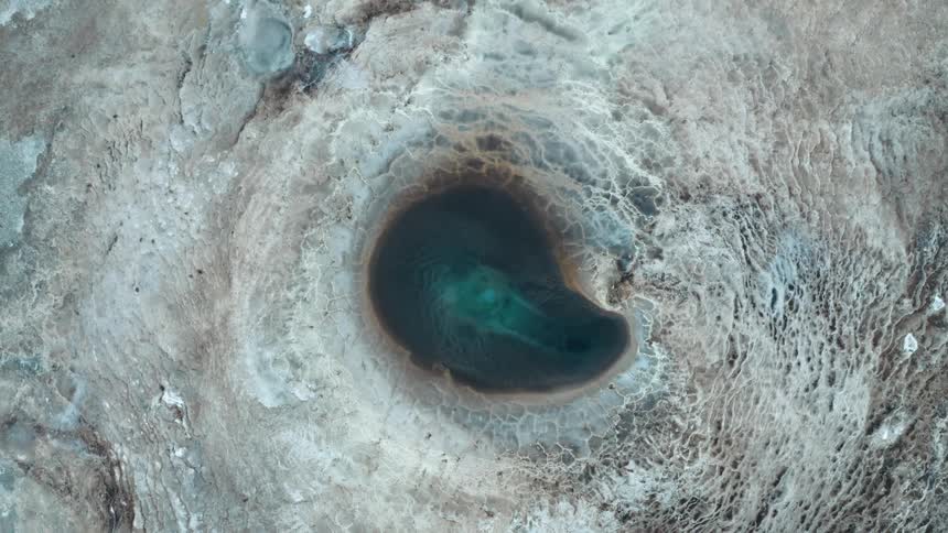 Aerial panorama of a crater with blue thermal water
