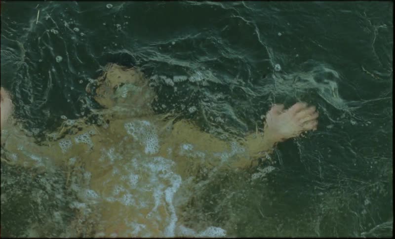 Man slowly sinking into the water