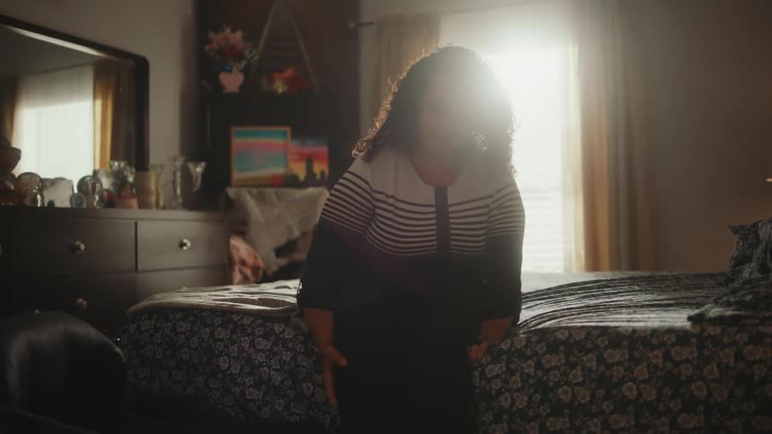 A clip of a disabled woman moving out of the bed and unto the wheelchair