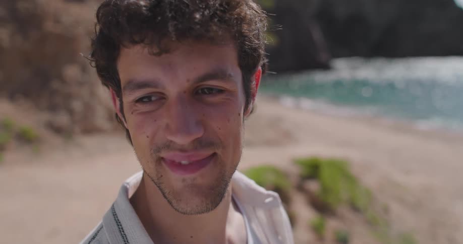 Portrait of a smiling man on the beach sand
