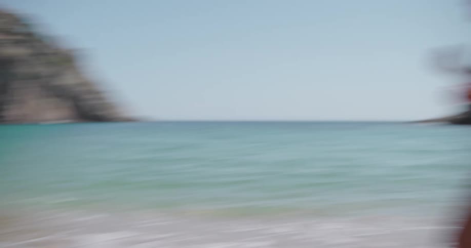 A man and a woman goof around on a beach