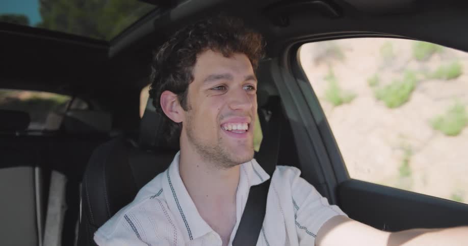 Portrait of a happy man driving a car