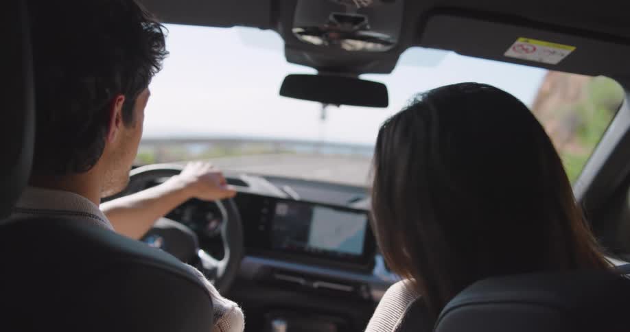 A young couple on a road trip near the ocean
