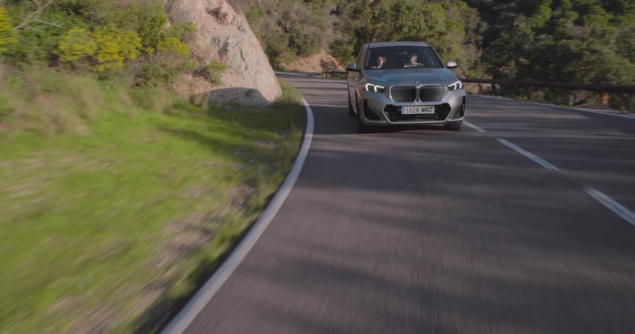 A car navigating a curvy mountain road near the ocean