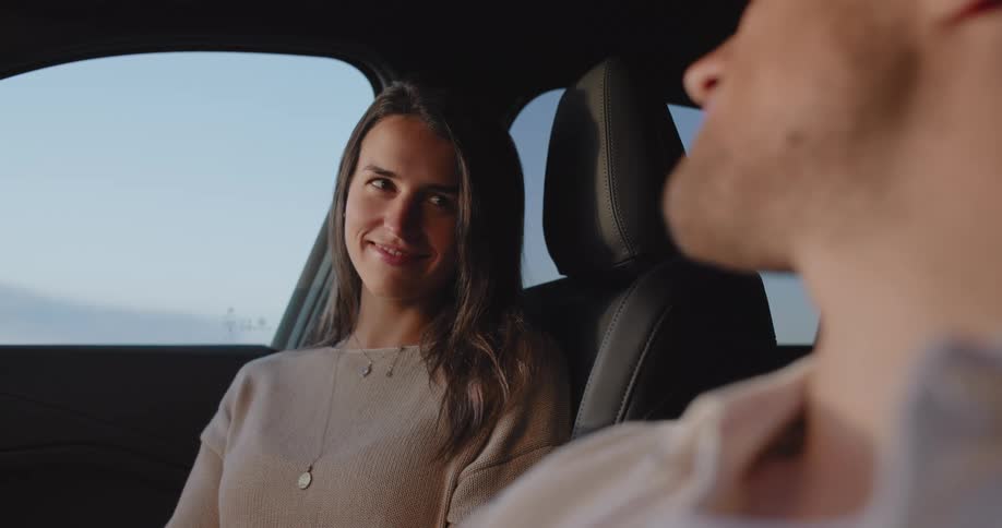 A clip of a couple in a car smiling at each other