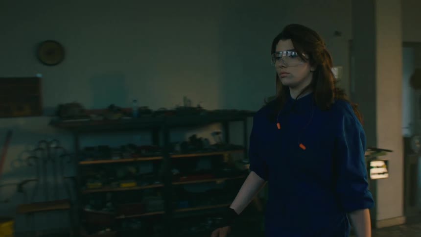 A factory worker works at the machine