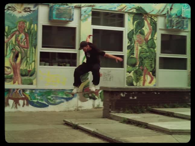 A person on a skateboard is performing a trick off the stairs