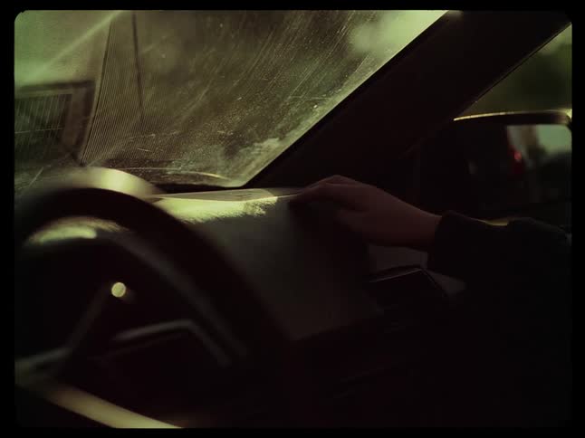 Hand of a child playing on the dashboard of a car