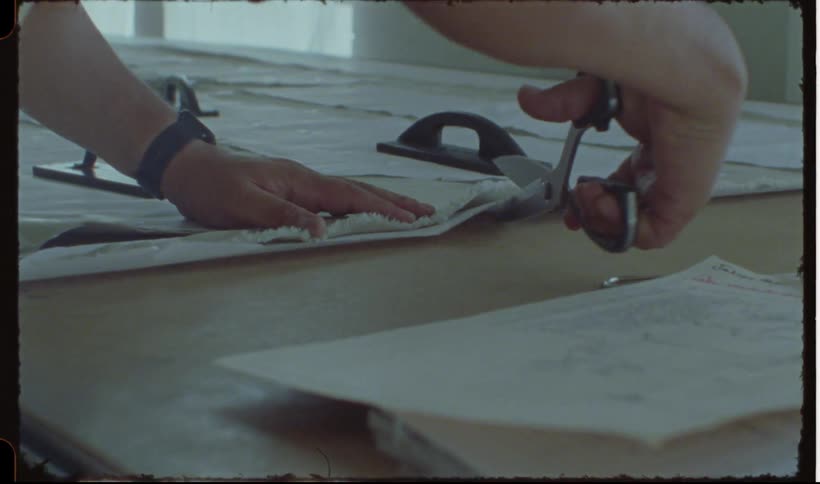 Closeup of a persons hands cutting patterns with a scissor