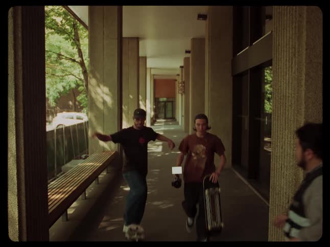 A couple of skaters stopped by a security guard