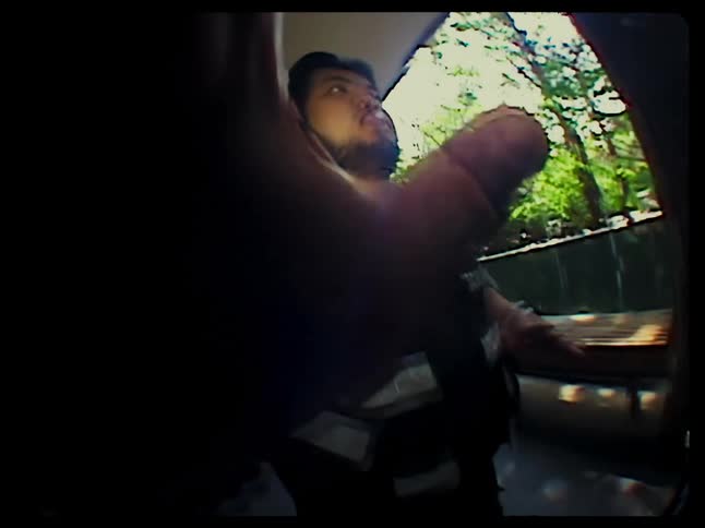 A man stretches his hand to stop a camera from filming