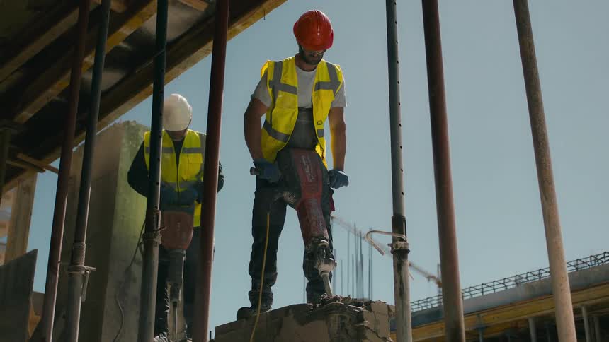 Construction workers are using jack hammers on the site