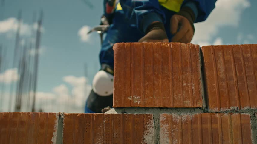 A clip of a person laying bricks