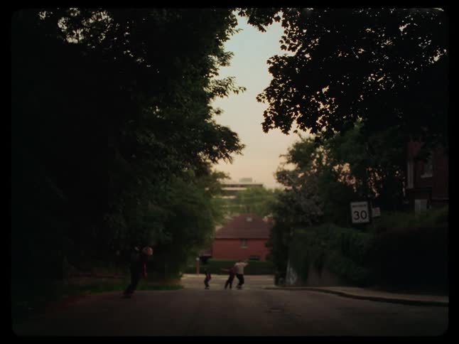 Group of friends skateboarding down a street