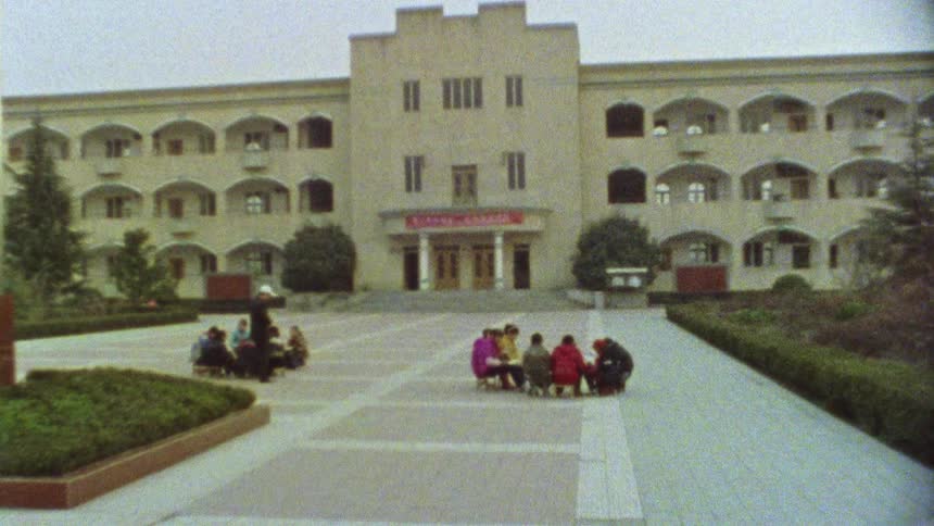 Two groups of people sitting in front of a building in china