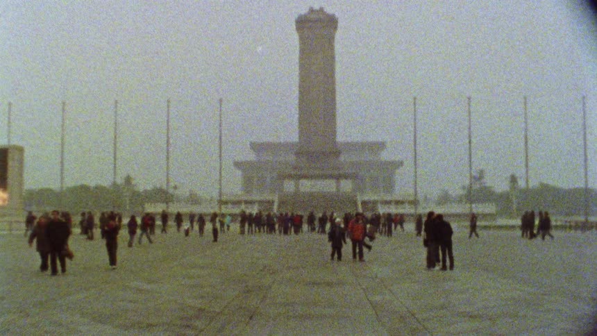 Tourists walking through Beijing's Tiananmen Square on a hazy day